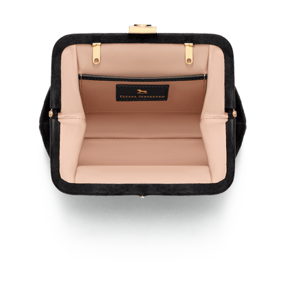 Suede bag with signature clasp and removable strap